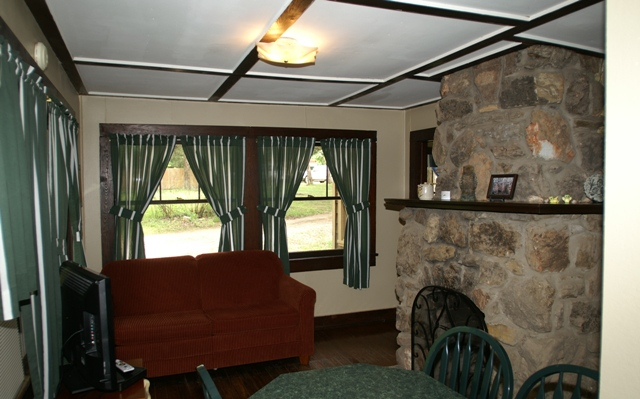 green kitchen and curtains with stone fireplace