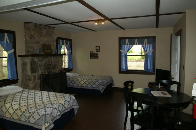 lodge with stone fireplace and blue curtains