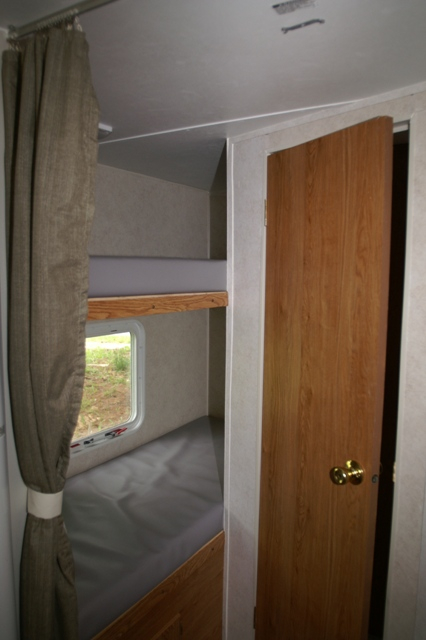 open door with bunk bed and curtain