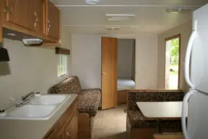 A kitchen with a sink, refrigerator and microwave.