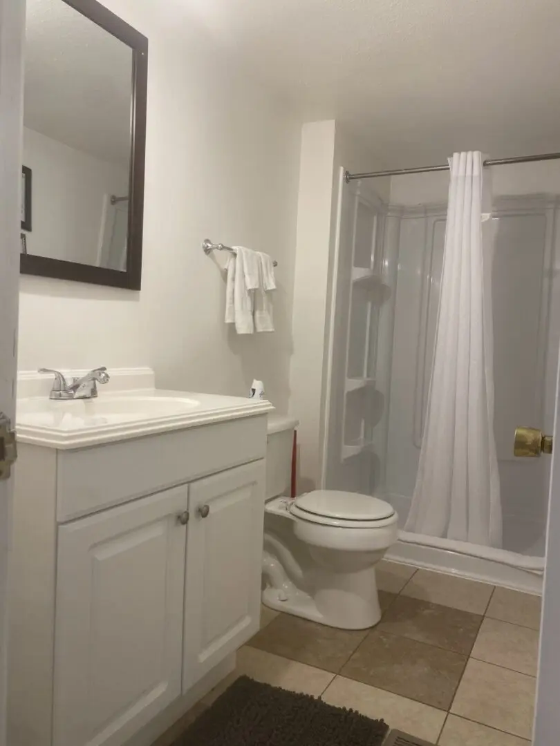 A bathroom with white cabinets and a toilet.