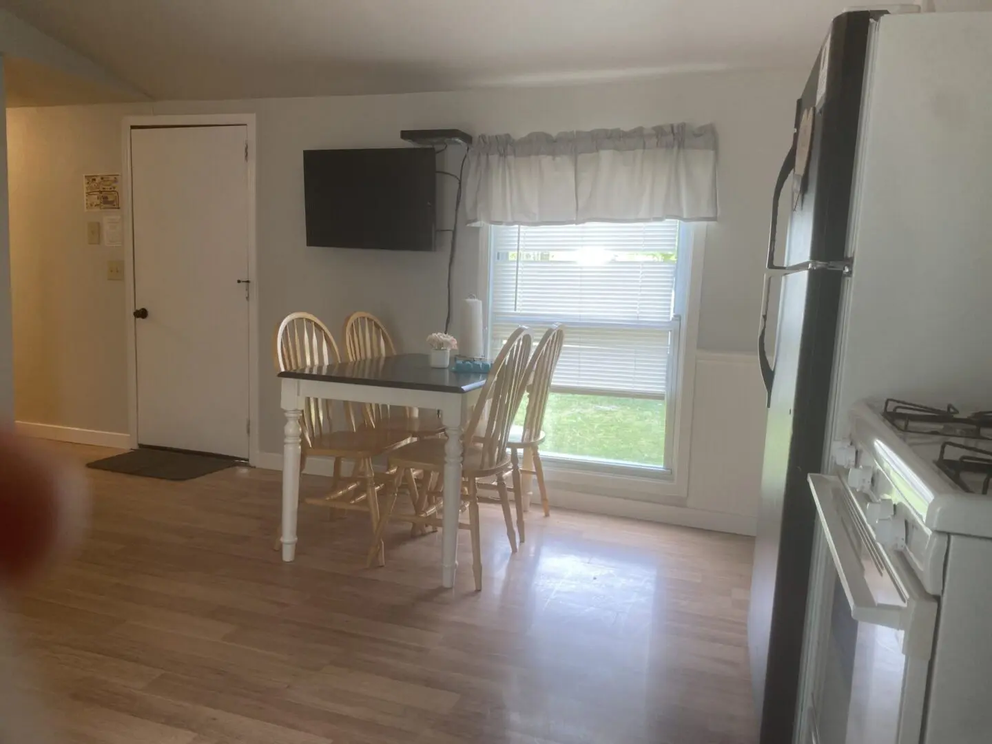 A table and chairs in the kitchen of a home.