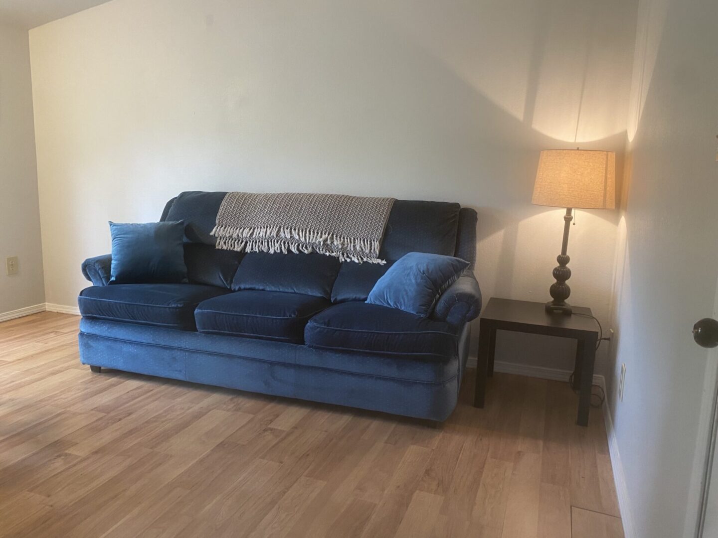 A couch and table in the corner of a room.