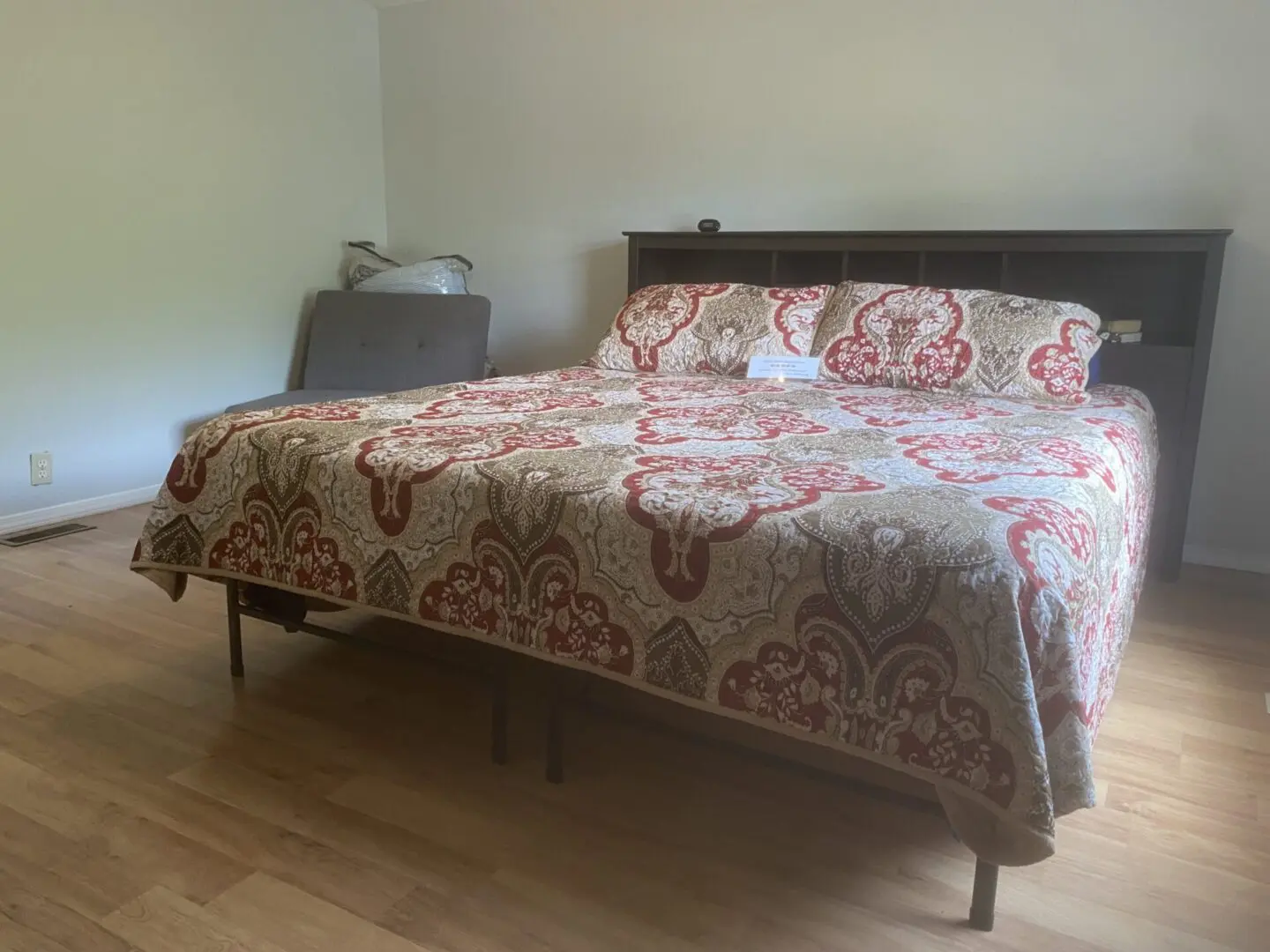 A bed with a red and white bedspread on it