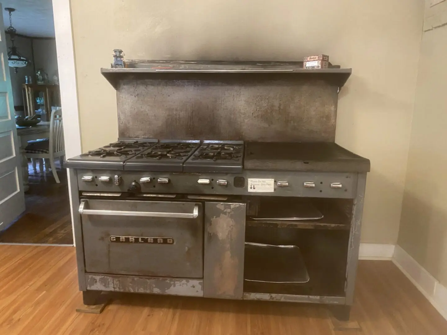A large metal stove with two ovens and a shelf.