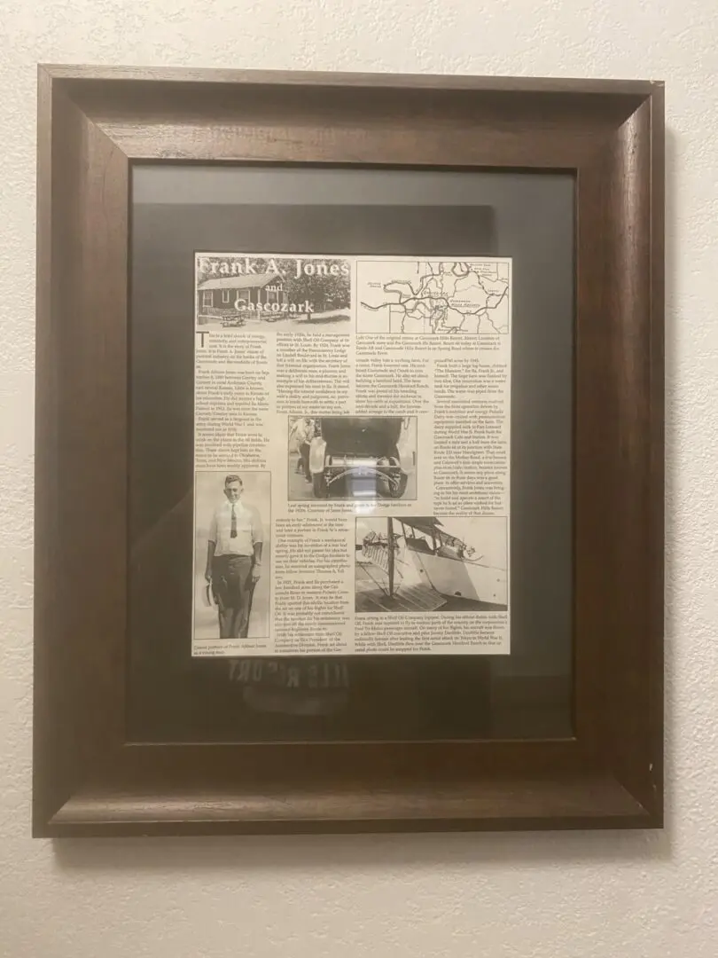 A framed newspaper with an old man standing next to it.