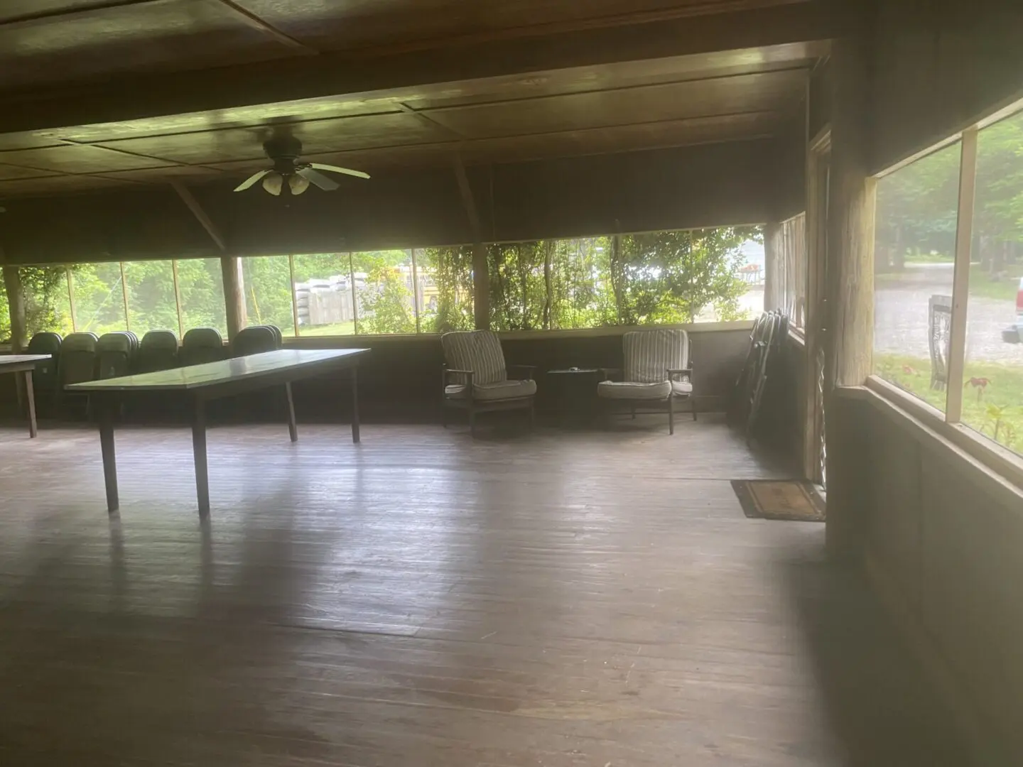 A room with wood floors and ceiling fans.