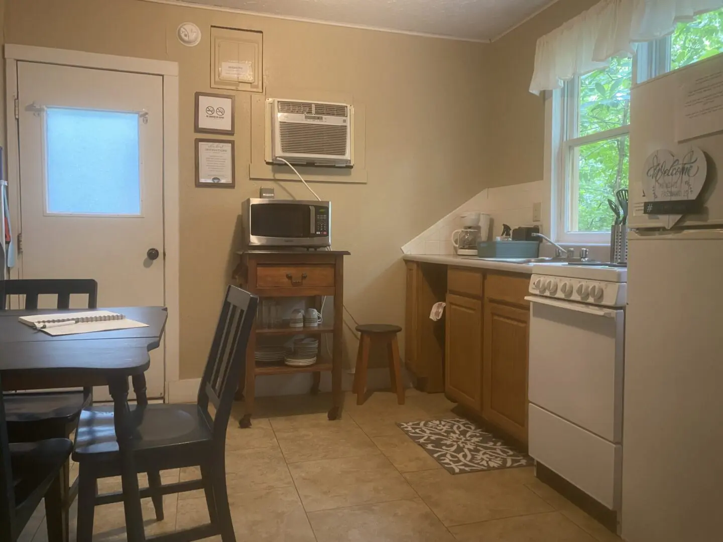 A kitchen with a microwave, sink and refrigerator.