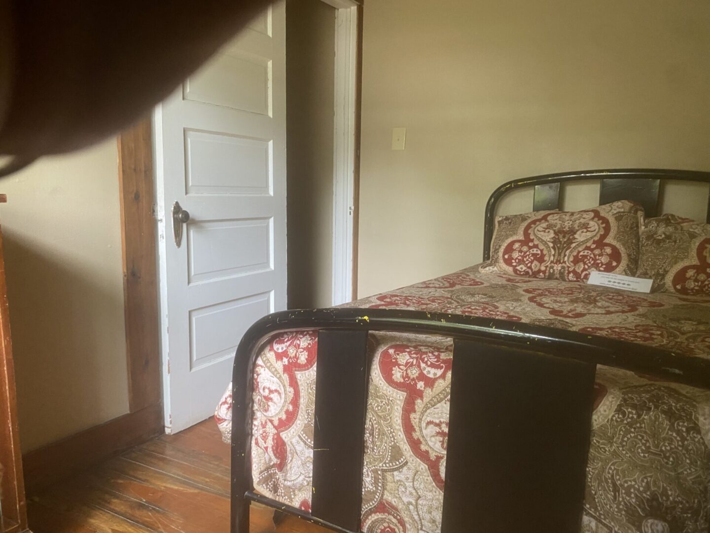 A bedroom with a bed and chair in it