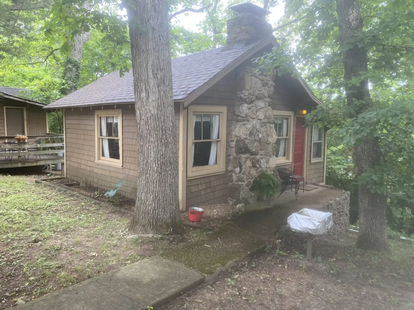 A small house sitting in the middle of a forest.