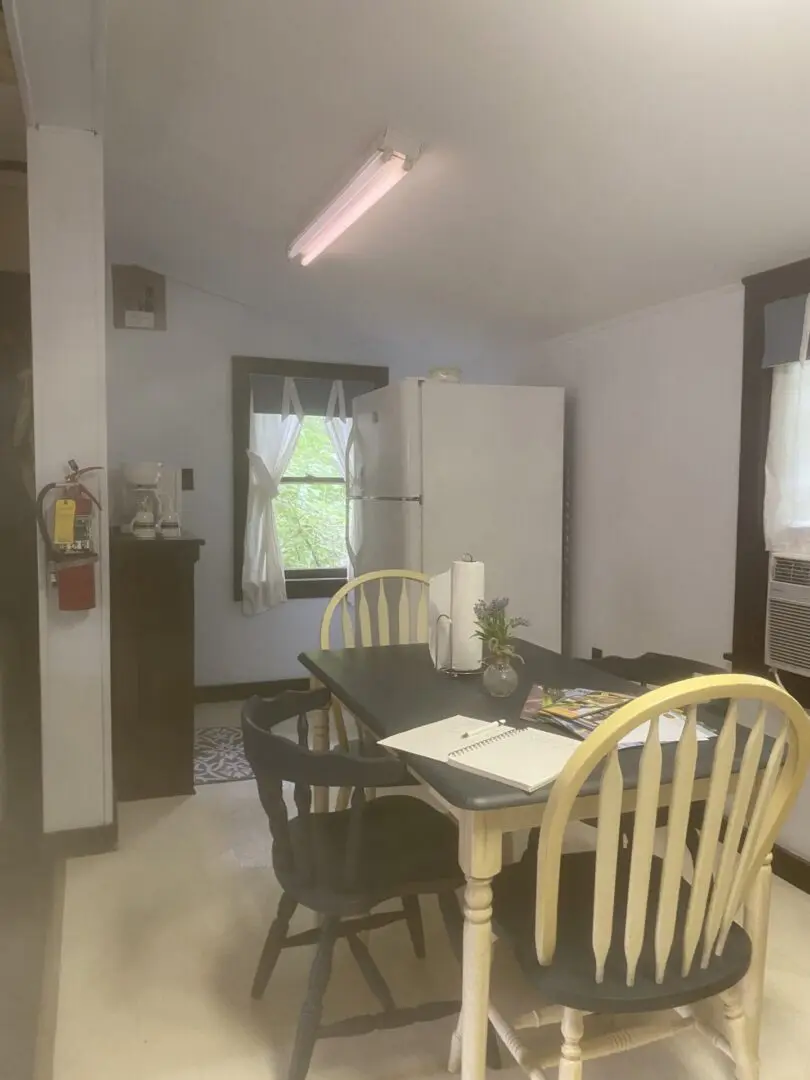 A kitchen with a table and chairs in it