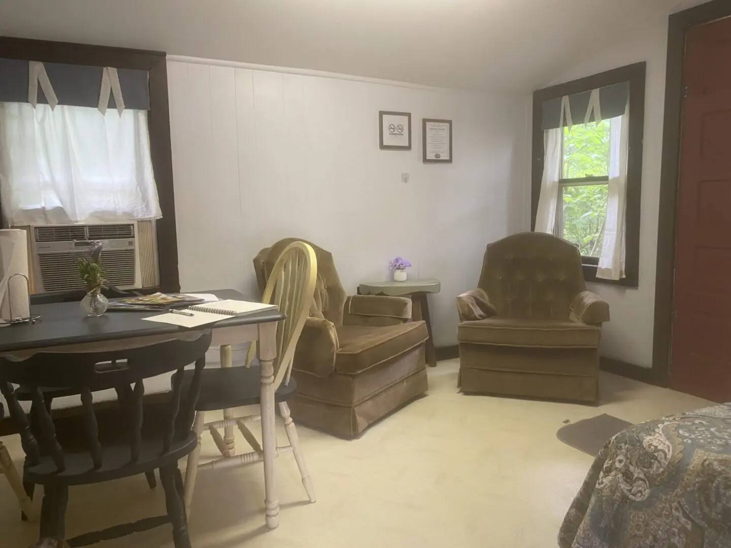 A living room with two chairs and a table