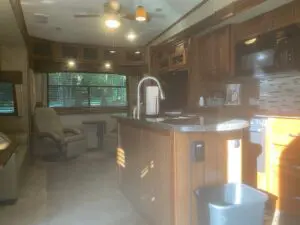 A kitchen with wood cabinets and a sink.