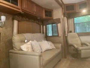 A couch and chair in the living room of an rv.