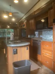 A kitchen with wood cabinets and granite counter tops.