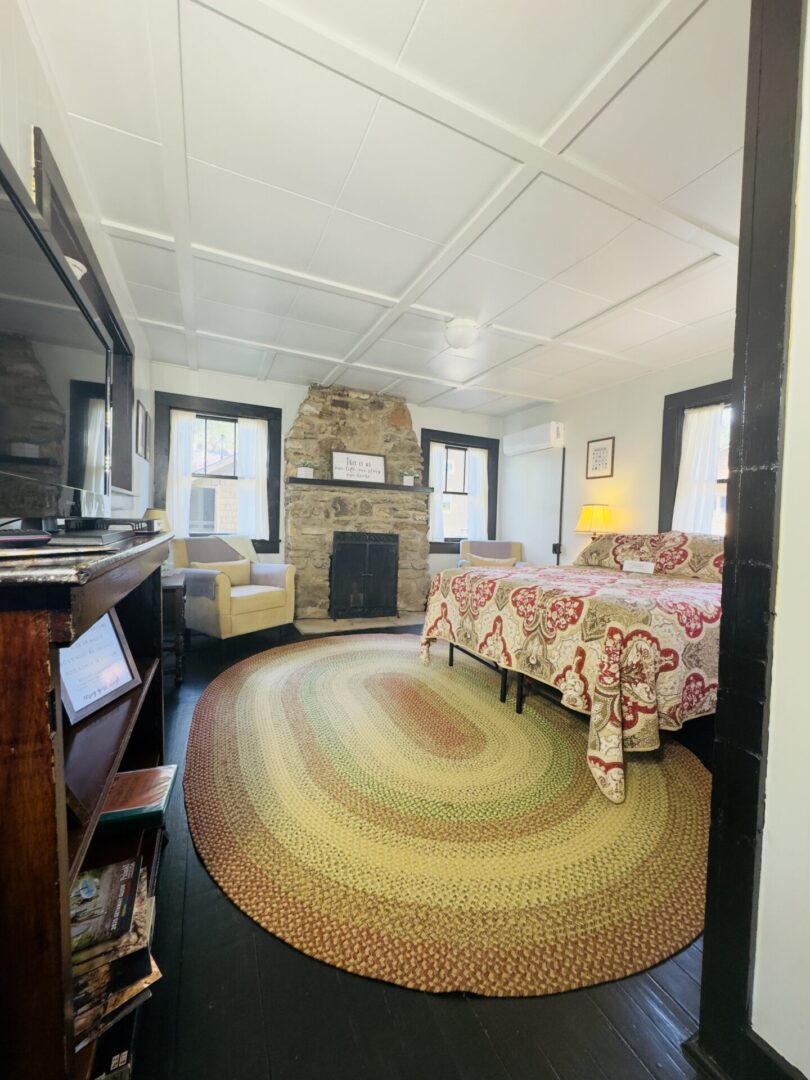 Cozy bedroom with a colorful rug.