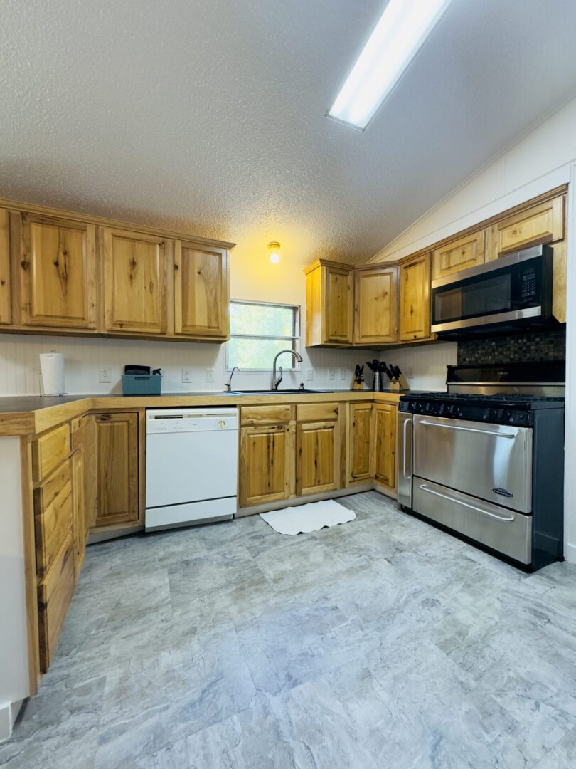 Wooden kitchen cabinets with modern appliances.