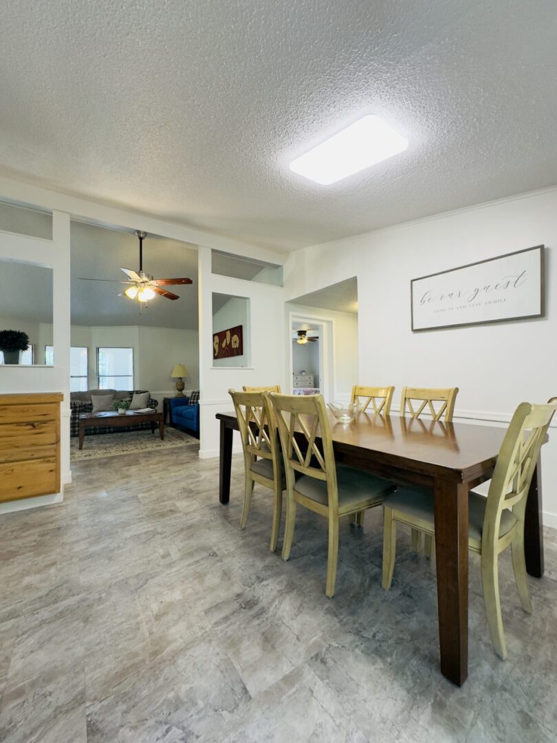 Dining room with wooden table and chairs.