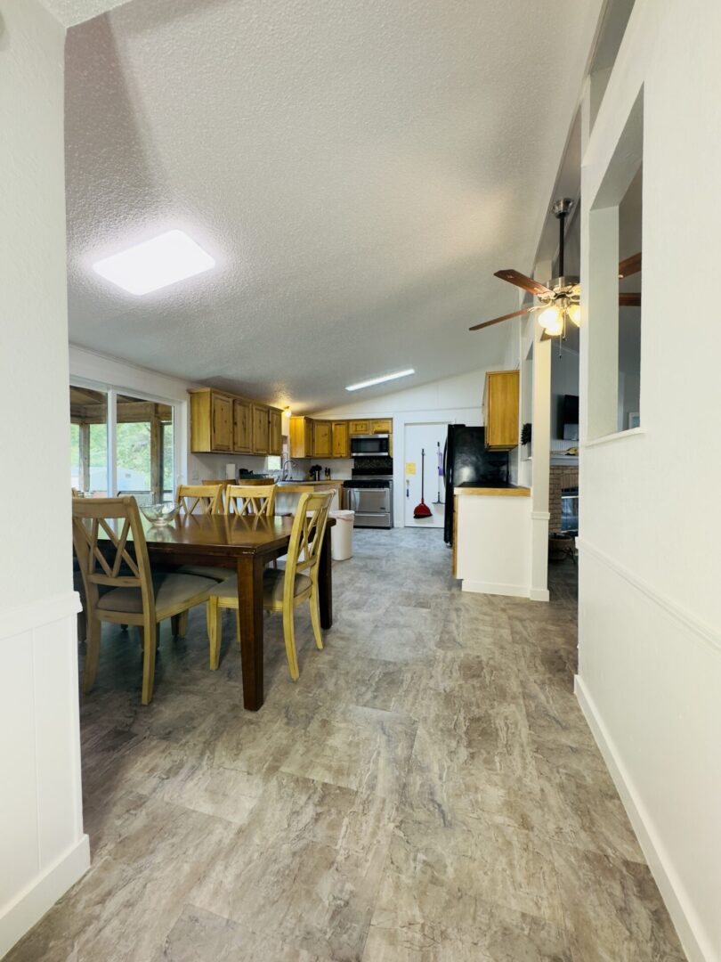 Open kitchen and dining area with table.